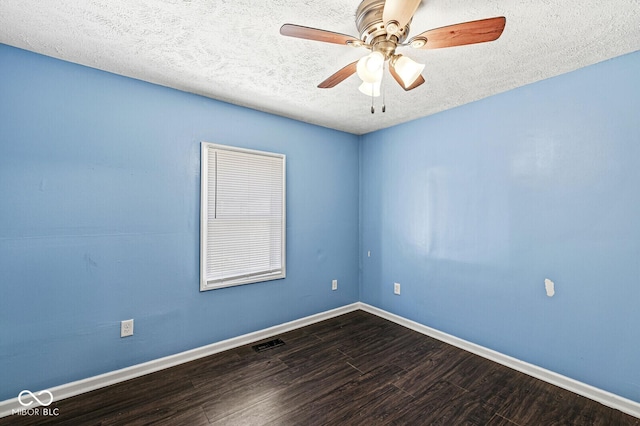 unfurnished room with visible vents, a textured ceiling, baseboards, and wood finished floors