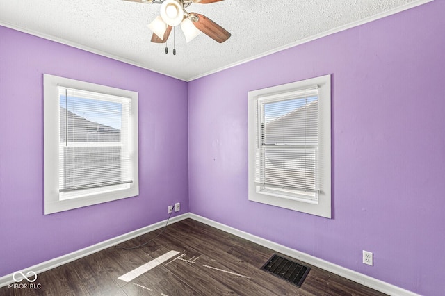 unfurnished room featuring baseboards, visible vents, dark wood-style flooring, and a textured ceiling