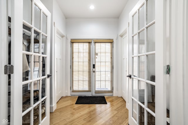 doorway to outside featuring recessed lighting, wood finished floors, and french doors