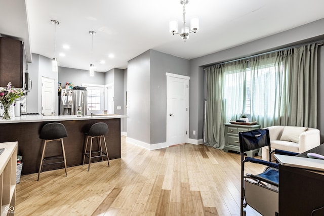 kitchen with a healthy amount of sunlight, light wood-style floors, appliances with stainless steel finishes, and light countertops