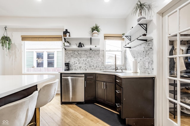 kitchen featuring light wood-style floors, open shelves, and dishwasher