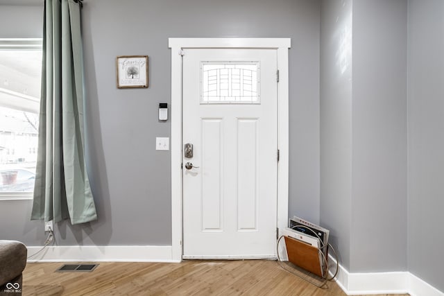 entryway featuring light wood-style flooring, visible vents, and baseboards