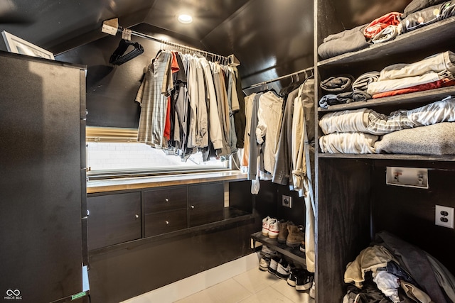 walk in closet with tile patterned floors