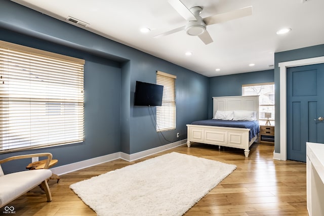 bedroom featuring recessed lighting, wood finished floors, visible vents, and baseboards