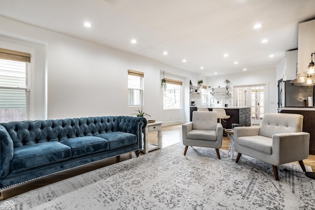 living room with light wood-style floors and recessed lighting