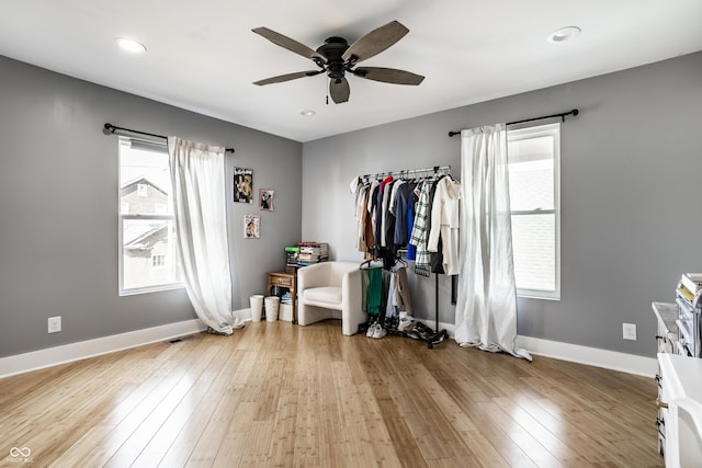 bedroom with hardwood / wood-style floors, recessed lighting, and baseboards