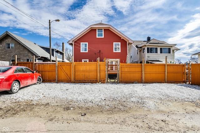 rear view of house with a gate and fence