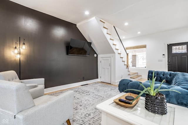 living area featuring stairs, baseboards, and recessed lighting