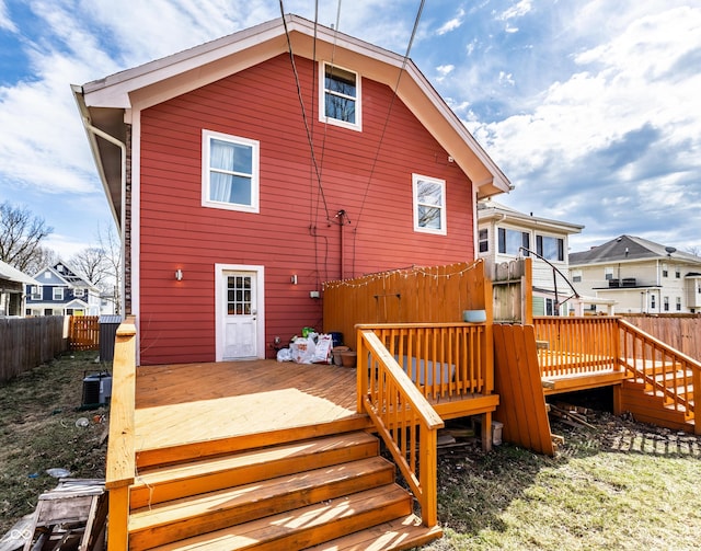 back of property featuring central AC unit, fence, and a wooden deck