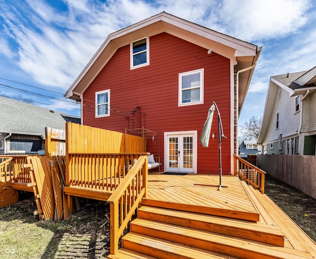 back of property featuring a wooden deck, fence, and french doors