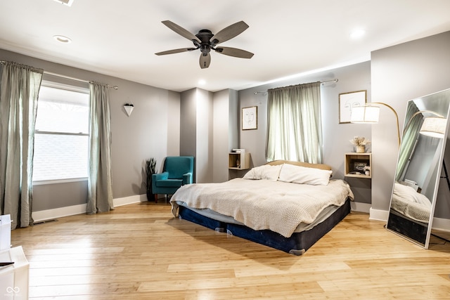 bedroom featuring ceiling fan, recessed lighting, light wood-style flooring, and baseboards