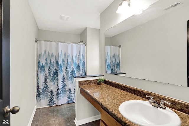 bathroom featuring tile patterned flooring, a shower with shower curtain, vanity, visible vents, and baseboards