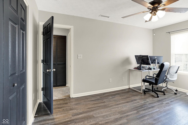 office space with visible vents, wood finished floors, a ceiling fan, and baseboards