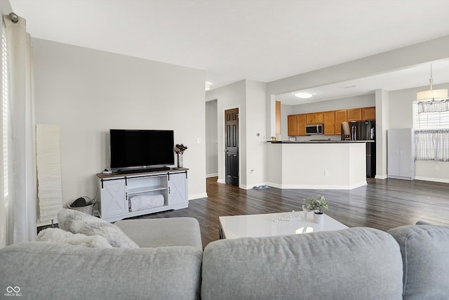 living room with dark wood-style floors and baseboards