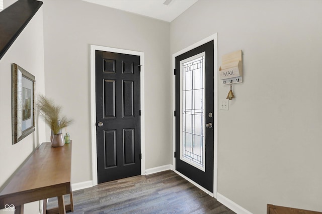 entryway featuring baseboards and dark wood finished floors