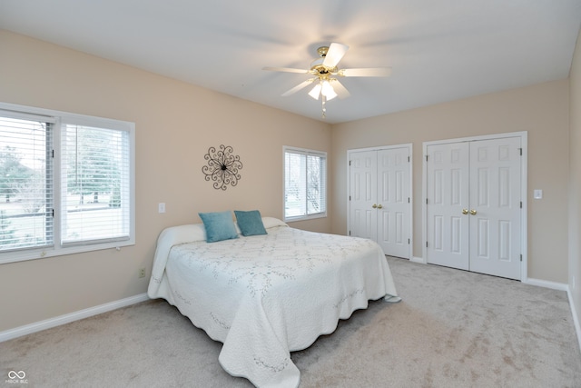 bedroom featuring multiple closets, carpet, and baseboards