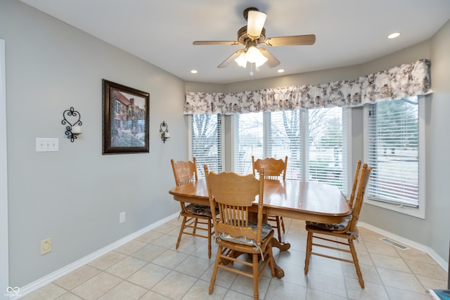 dining area featuring light tile patterned floors, visible vents, and baseboards