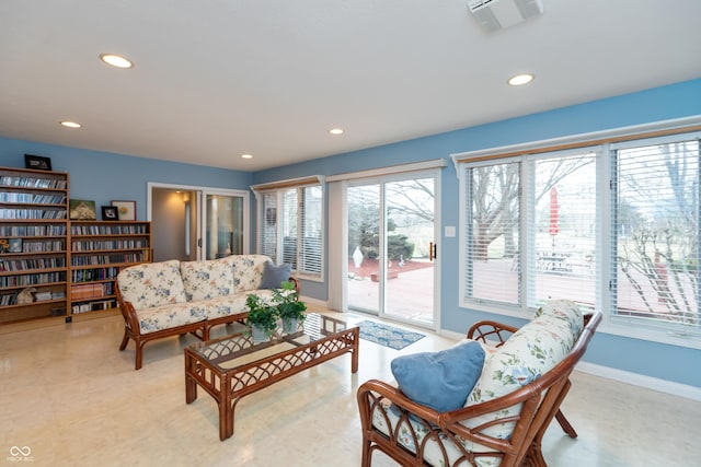 living room featuring baseboards, visible vents, and recessed lighting