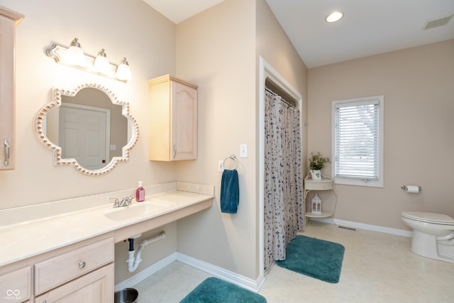 bathroom featuring toilet, recessed lighting, a sink, visible vents, and baseboards