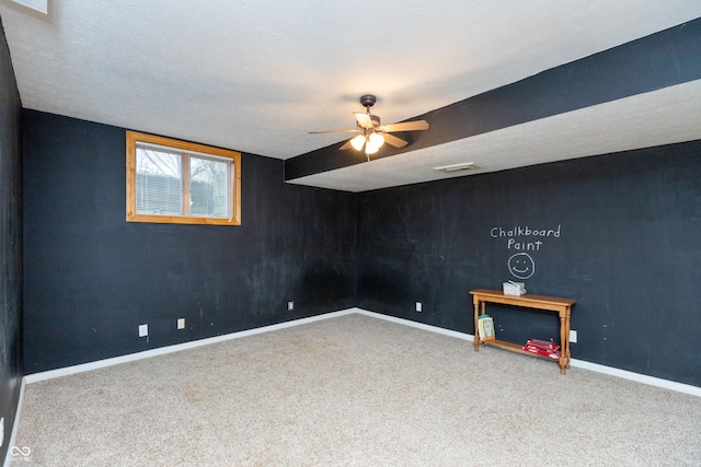 interior space featuring ceiling fan, visible vents, baseboards, and a textured ceiling