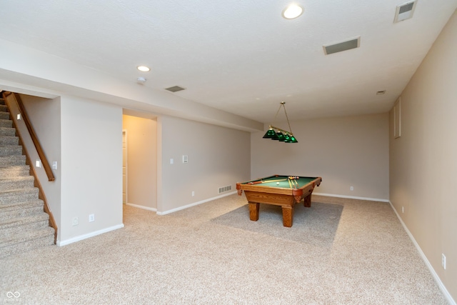 recreation room with carpet flooring, visible vents, and baseboards