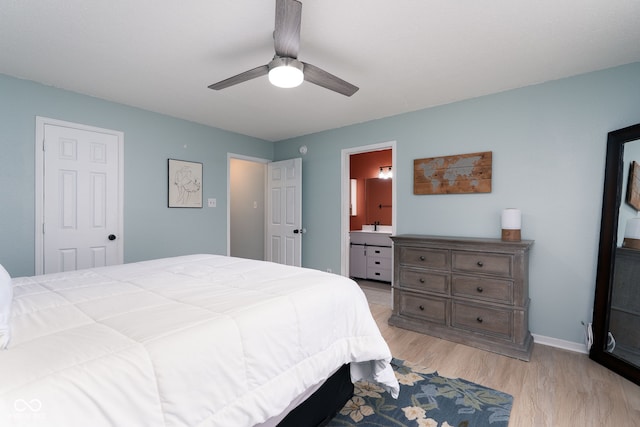 bedroom with light wood-style floors, connected bathroom, baseboards, and a ceiling fan