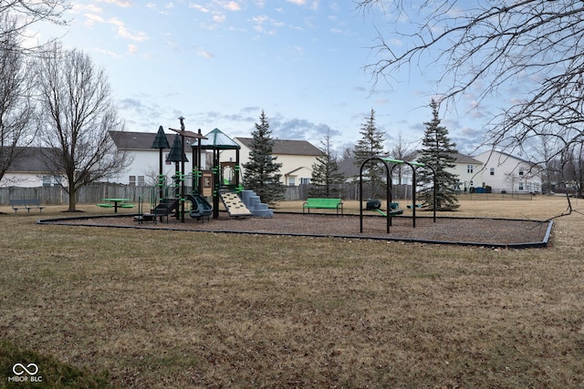 communal playground with a lawn and fence