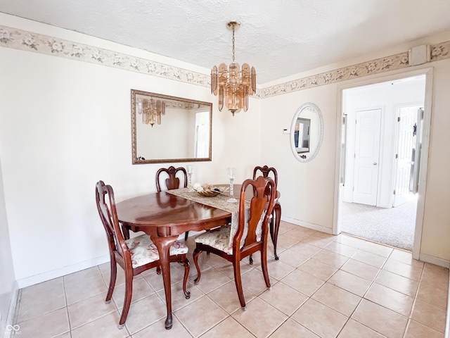 dining area with a textured ceiling, light tile patterned flooring, a notable chandelier, light carpet, and baseboards