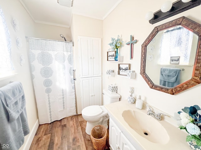 bathroom with toilet, wood finished floors, curtained shower, crown molding, and vanity