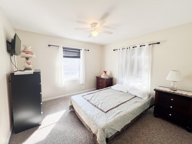 bedroom featuring dark colored carpet, a ceiling fan, and baseboards