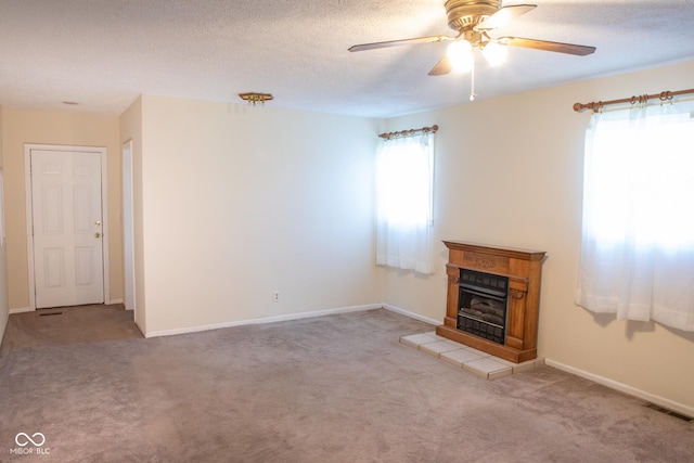 327 Maxwell Rd, Indianapolis, IN 46217 - unfurnished living room with ceiling fan, carpet flooring, a fireplace, a textured ceiling, and baseboards
