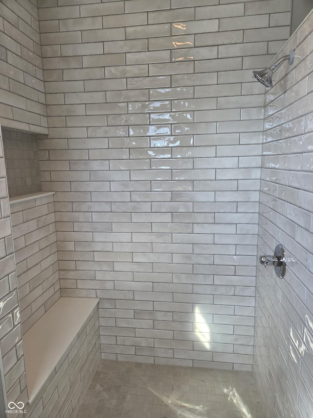 full bath featuring a tile shower