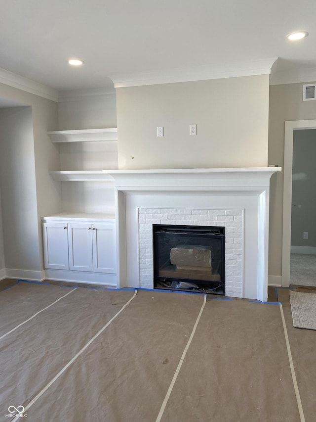 interior details featuring ornamental molding, a brick fireplace, and recessed lighting