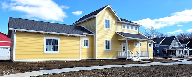 view of front of house featuring roof with shingles and a residential view