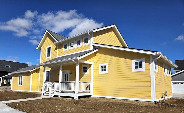 view of front of house featuring a garage and covered porch