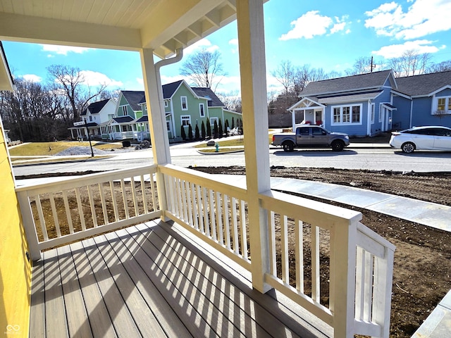 wooden deck with a residential view and a porch