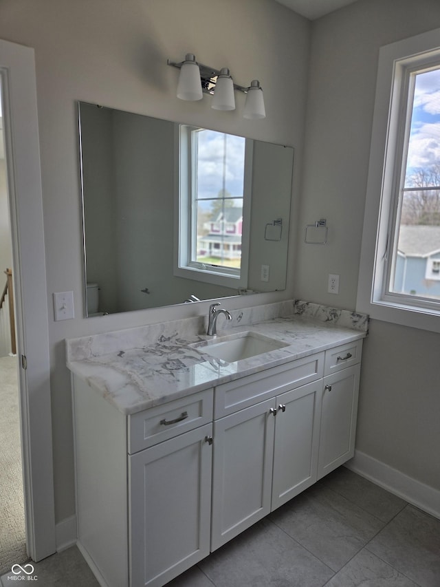 bathroom featuring baseboards and vanity