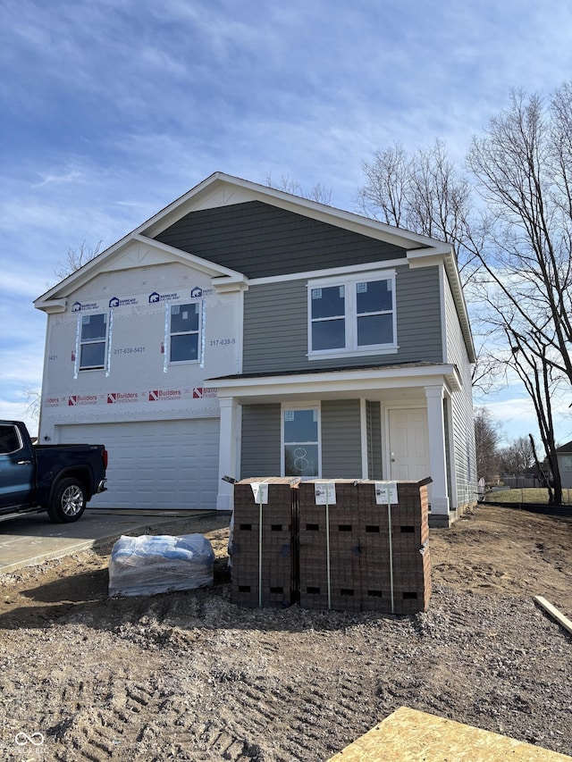 view of front of house with a garage, covered porch, and driveway