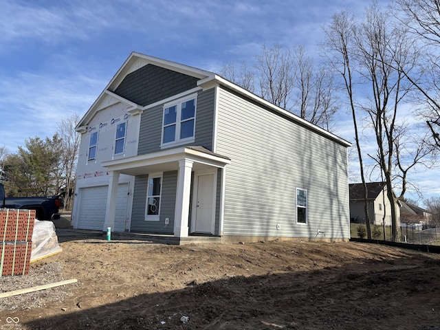 view of front facade featuring an attached garage and fence