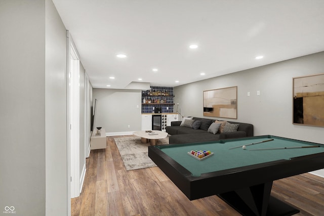 game room featuring baseboards, wine cooler, a dry bar, recessed lighting, and wood finished floors