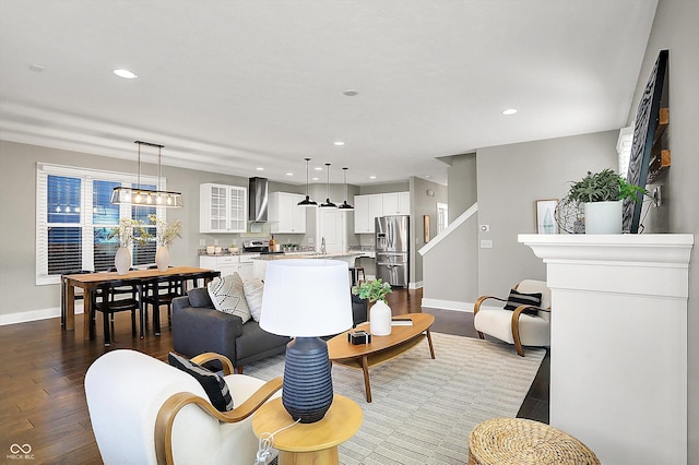 living room featuring recessed lighting, baseboards, and dark wood-style flooring