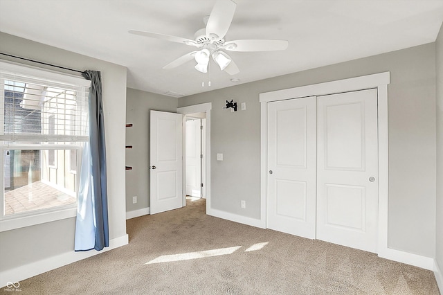 unfurnished bedroom with a closet, ceiling fan, baseboards, and carpet floors