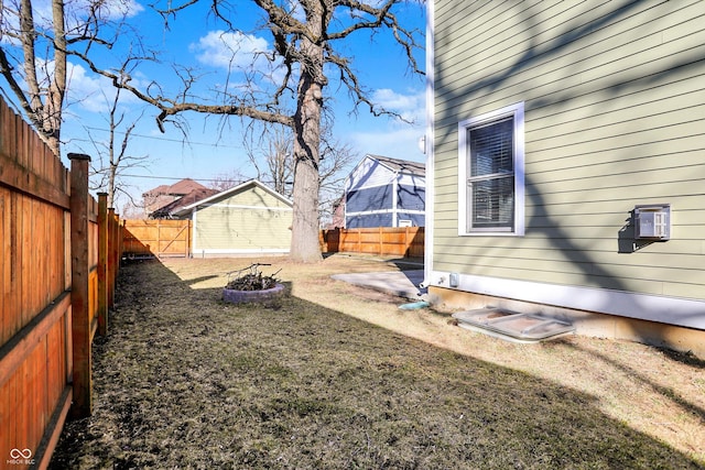 view of yard with a fenced backyard and an outdoor fire pit