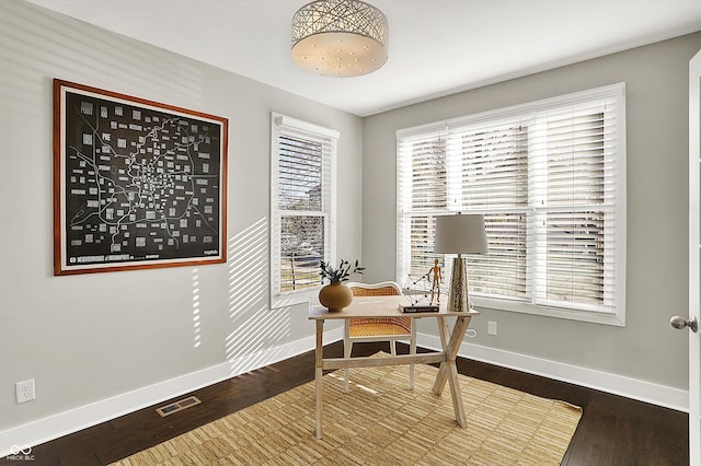 home office with visible vents, baseboards, and wood finished floors