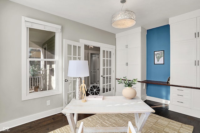 office area with dark wood finished floors, french doors, and baseboards