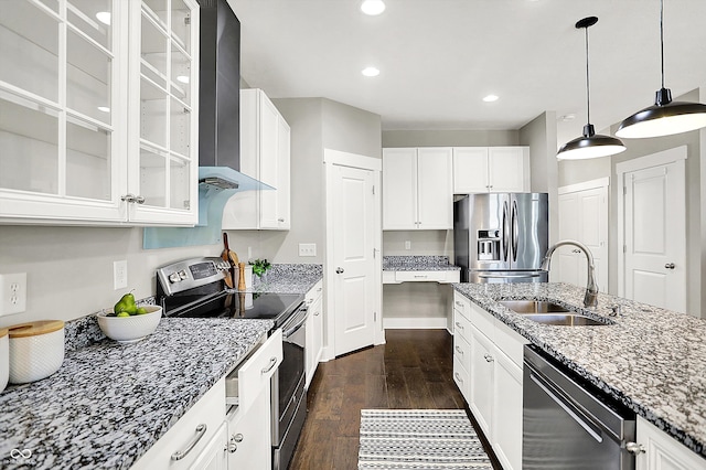 kitchen featuring a sink, dark wood finished floors, stainless steel appliances, wall chimney exhaust hood, and light stone countertops