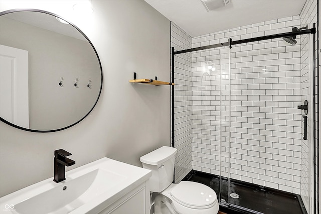 full bathroom featuring vanity, toilet, visible vents, and a stall shower