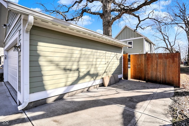 view of home's exterior with board and batten siding and fence