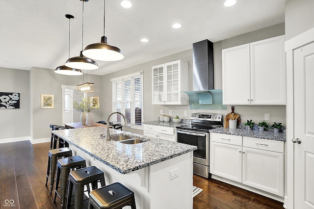 kitchen with a sink, a kitchen breakfast bar, electric range, wall chimney exhaust hood, and dark wood-style flooring