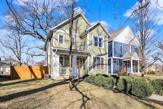 view of front of house with a porch, central AC, a front yard, and fence